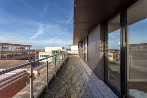 A spacious wrap-around balcony featuring outdoor seating, available during the spring and summer months.