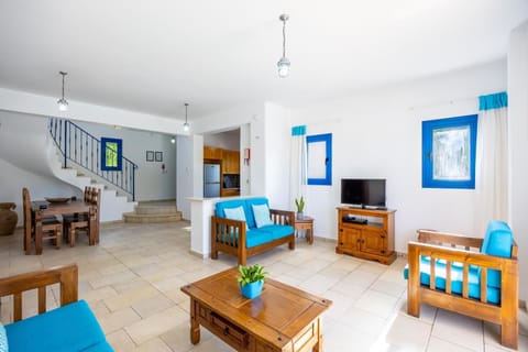 Open-plan living room with sofa, dining area, kitchen, WiFi internet, and satellite TV