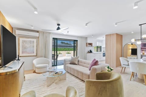 This open plan living and dining space is beautifully styled with modern amenities and accents.