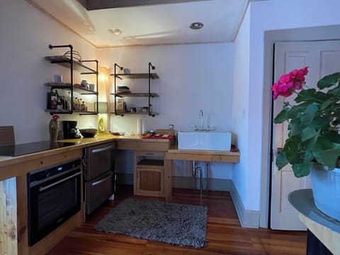 Kitchen with induction cooktop and drawer refrigerator
