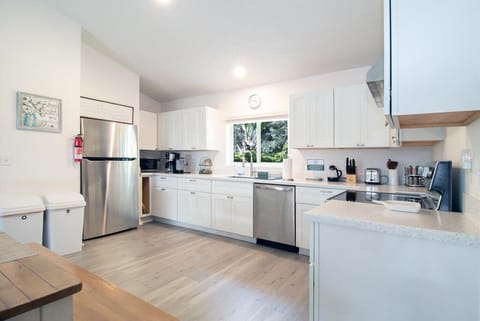 Full kitchen with fridge, dishwasher, oven, microwave, coffee maker & tea kettle