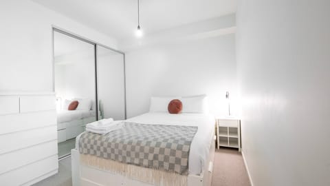 Rest easy in this comfy queen-size bed with fresh linen, ensuring a peaceful night's sleep.