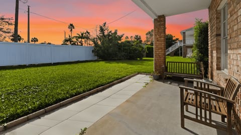 Enjoy morning coffee or evening relaxation on the patio overlooking the grassy backyard.