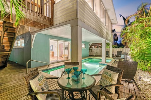 Pool with surround deck, tables, seating, and chaise lounges all around the pool area.