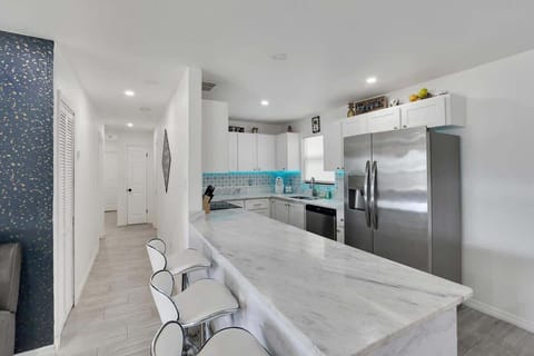 Pull up a stool, relax, and enjoy a drink at the stylish kitchen bar.  #BarCentral #ChillOutTime #TampaLiving