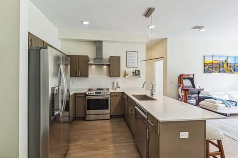 The sleek, open kitchen offers ample space & every home comfort