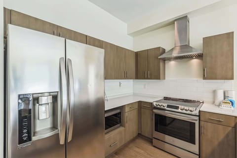 The sleek, open kitchen offers ample space & every home comfort