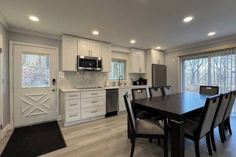Open style kitchen with a large sliding door access to a deck