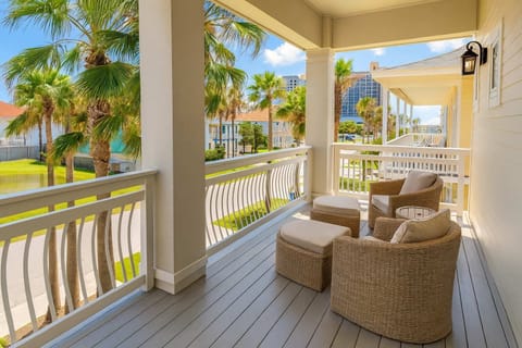 Relax on a breezy balcony with palm-lined views—coastal charm, comfy seating, and walkable to beach & dining.