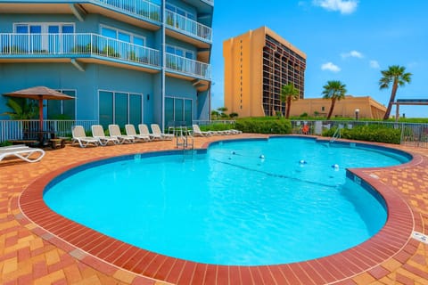 Resort-Style Beachfront Pool Deck
Soak up the sun at this resort-style outdoor pool with ample loungers, brick sundeck, and coastal high-rise backdrop, perfect for refreshing swims, family fun, and relaxing after a day on the nearby beach.