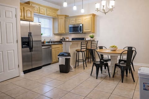 Modern kitchen & dining with granite counters, stainless steel appliances, pendant lighting, and cozy seating—perfect for cooking, gathering, and relaxing in style.