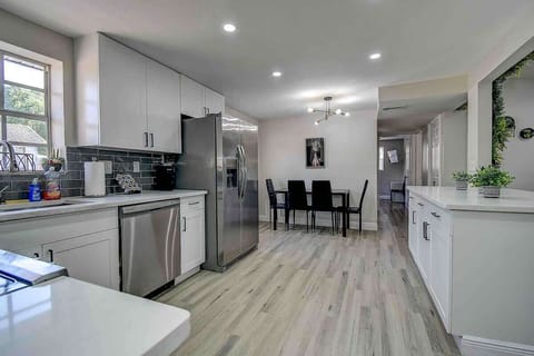 Spacious kitchen with a stylish bar counter for quick bites or morning coffee. #KitchenVibes #BarSeating #TampaHome