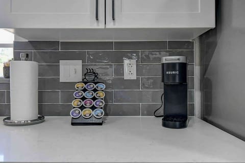 Brew your morning cup with complimentary coffee in this stylish kitchen! #FreeCoffee #KitchenVibes #TampaRetreat