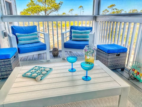Located off the main area, enjoy the serenity of the porch...Gulf breezes melt your cares away.
