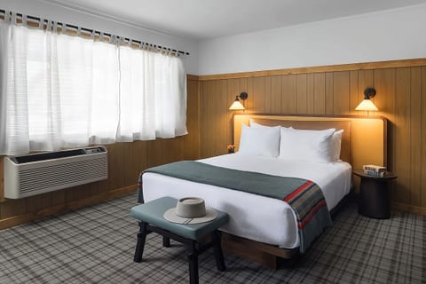 Recharge in a quiet room with calming mountain scenery.