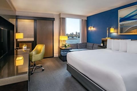 Unwind in a plush king bed with skyline views.