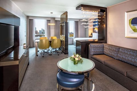 Relax in a stylish suite with lounge seating and warm lighting.