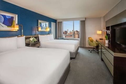 Unwind in bright double-queen comfort with skyline views.