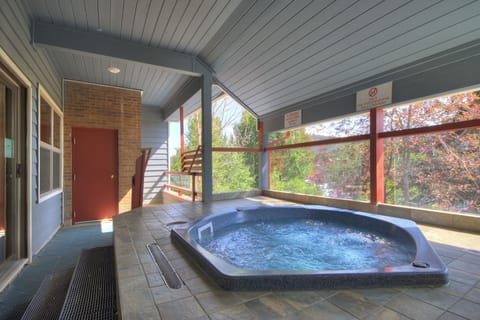 Covered hot tub with forest views