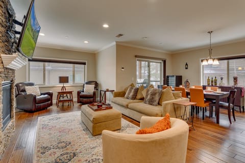 Living area with comfy couch. stone fireplace, and flat screen TV