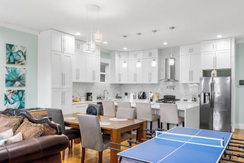 A multi game table which includes table tennis, pool, foosball and air hockey.