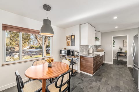 Charming breakfast nook by the window, perfect for starting your day in a cozy, sunlit spot.