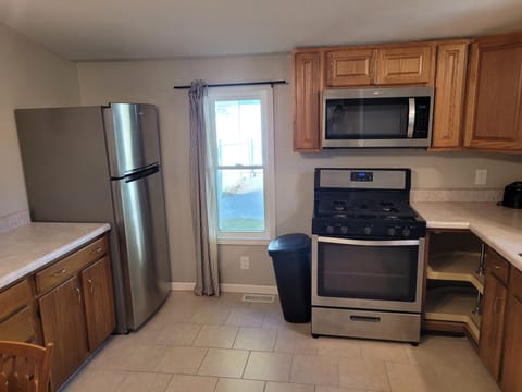 KITCHEN:  The home has a fairly large kitchen with all appliances including a dishwasher.  Also has a good supply of cooking and dining utensils.