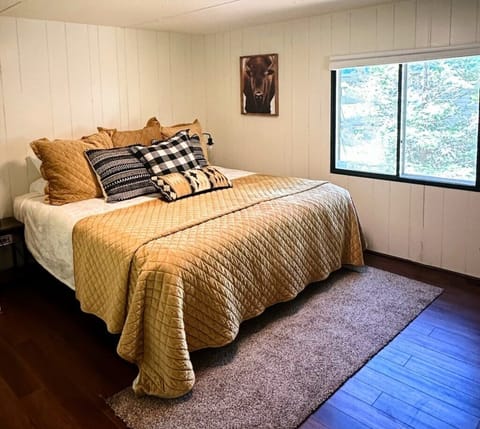 Spacious master retreat with a cozy king-sized bed and flatscreen TV—your space to unwind.