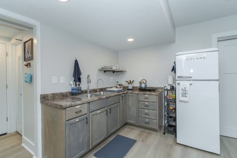 kitchen with dishes, pots/pans, prep tools, two burners, purified drinking water