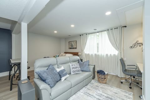 leather recliner couch facing the electric fireplace and 65" TV