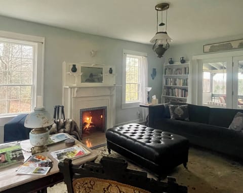 Spacious, light-filled living room with a wood-burning fireplace