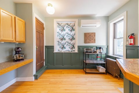 Enjoy a cozy meal in this charming kitchen, featuring modern amenities and a warm, inviting atmosphere.