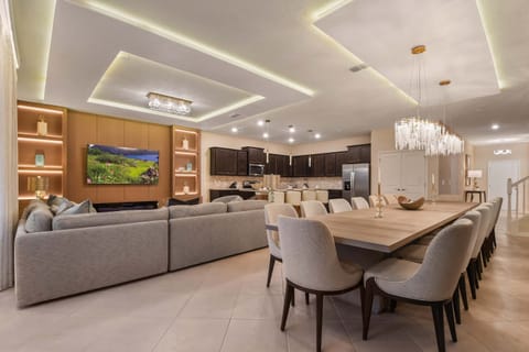 Open-concept living, dining, and kitchen with upscale modern decor.