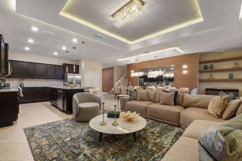 Spacious open-concept living, dining, and kitchen with elegant decor.