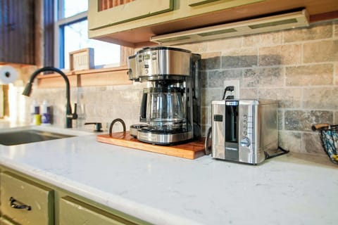 Start your mornings with a fresh brew at this fully stocked coffee station, complete with a modern coffee maker and toaster. A thoughtful touch for caffeine lovers to kickstart their day.