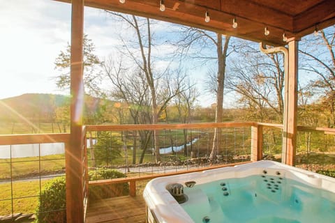 Unwind in the covered hot tub with hillside views—perfect for sunsets & stargazing.