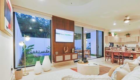 Bright open living area with garden views and seamless indoor-outdoor dining.