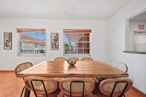 Bright and inviting dining area with ample seating and charming decor, perfect for family gatherings.
