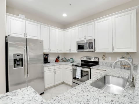 Modern kitchen with stainless steel appliances and granite countertops