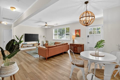 Bright and inviting living space with modern decor, soft lighting, and a smart TV for cozy nights in.