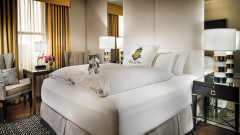 Sink into plush comfort beside glowing lamps and cozy seating.