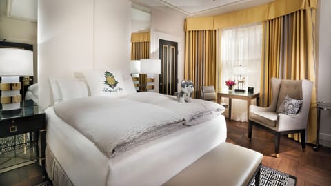 Sink into crisp linens in a bright, elegant bedroom.