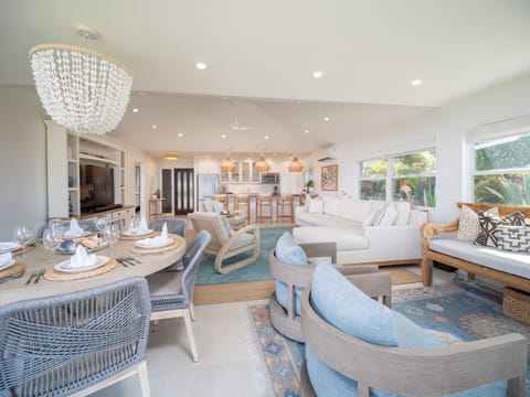 Enjoy a spacious living and dining area with ample seating and ocean views, designed for comfort and relaxation in style.