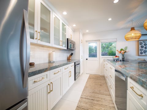 Bright, fully equipped kitchen with stainless steel appliances and ample counter space, perfect for family meals or cooking local cuisine.