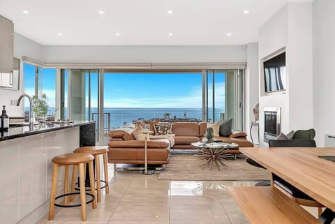 Unwind in the open-plan living area, where floor-to-ceiling glass doors perfectly frame breathtaking oceanfront vistas. Please note that the gas fireplace is currently unavailable.