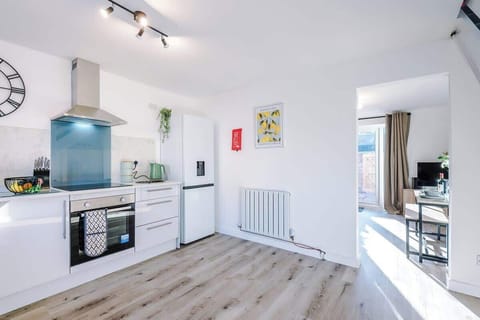 The kitchen is fully equipped with modern appliances, including a coffee machine, making it a perfect space for preparing meals and enjoying your morning brew. It offers ample counter space and storage, ideal for both cooking and casual dining.