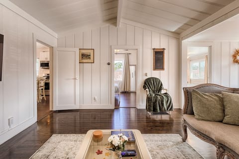 Cathedral ceiling living room connected to kitchen and dining area
