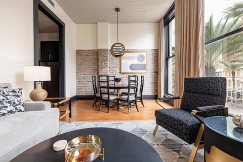Bright and inviting living and dining area featuring floor-to-ceiling windows that offer stunning views of Canal Street.