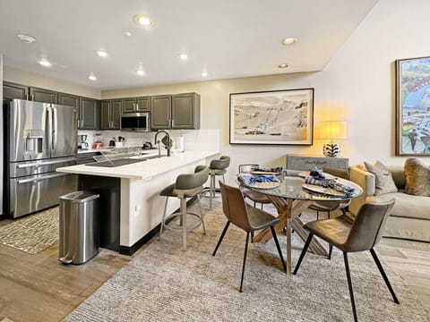 Enjoy seamless entertaining in this dining area, perfectly separated from the full kitchen by the elegant island. The open design lets conversation flow while keeping cooking contained, ideal for warm, home cooked meals.