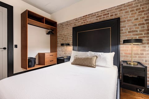 Bedroom 1 - Closet space equipped with hangers and laundry hamper.